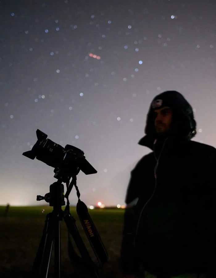 Guests stargazing through telescopes at night