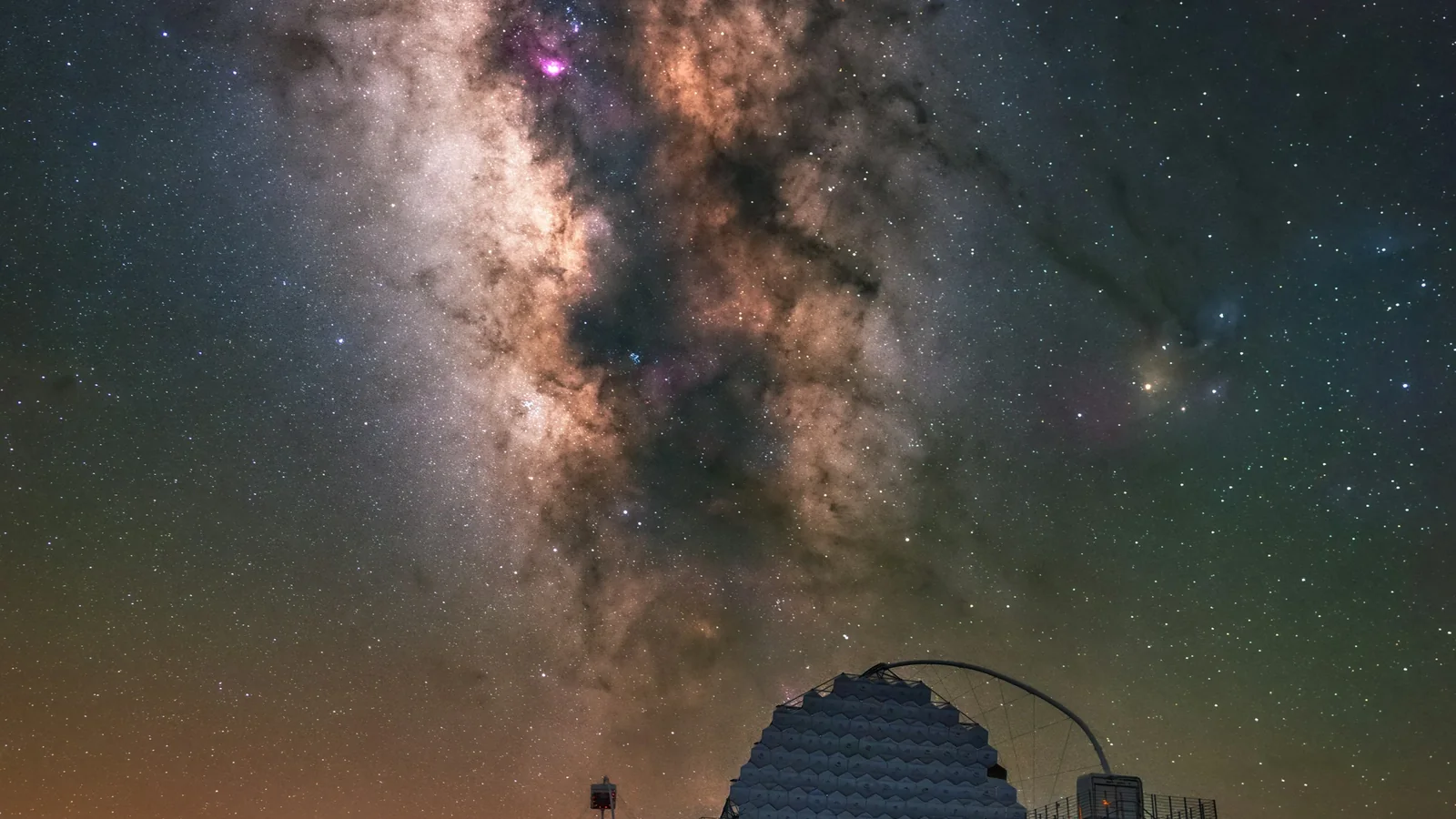 Telescopes set up under a dark, star-filled sky at The Eighth Element Observatory